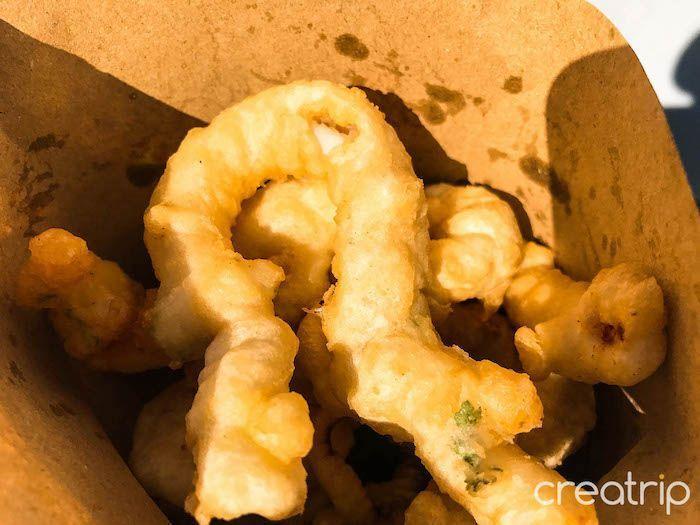 Freshly fried Korean squid rings, showcasing a popular snack that can be found at local 5-day markets.