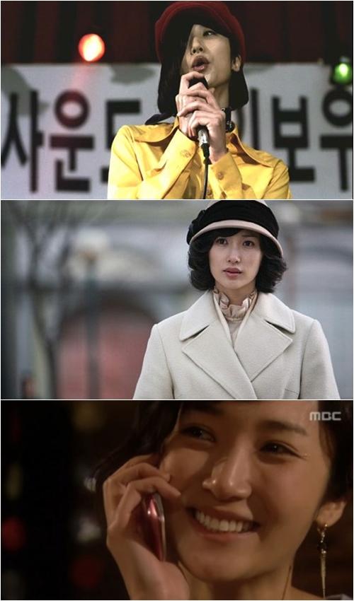 ステージ上で黄色いジャケットを着てマイクを持つ人物の写真。背景にはライトが見える。