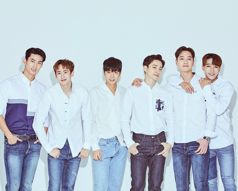 2PM團體照，白色襯衫配藍色牛仔褲背景為白色牆壁