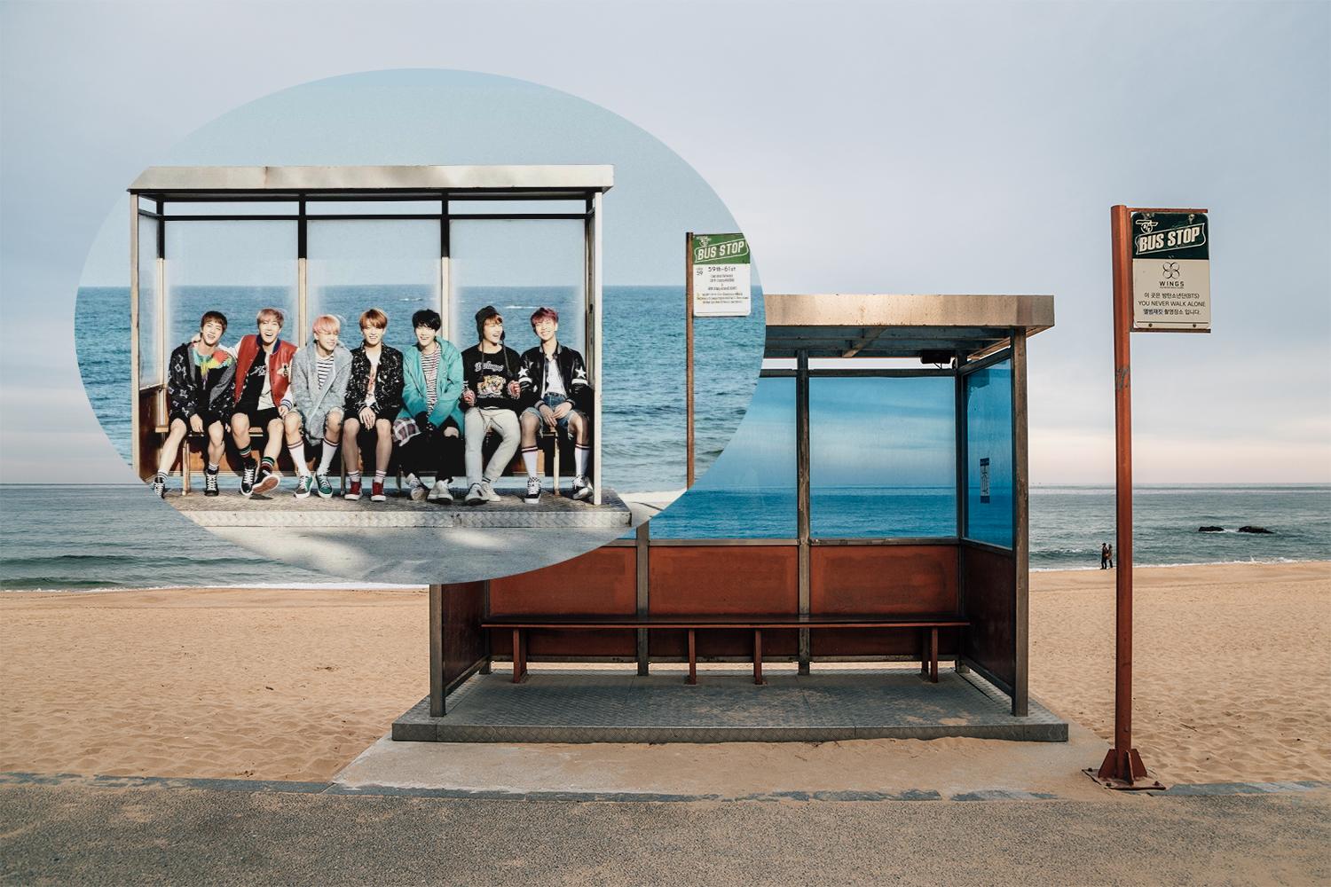 สมาชิกวงดนตรี BTS นั่งอยู่บนป้ายรถเมล์ริมหาดในคังนึง สถานที่ถ่ายทำมิวสิควิดีโอ Spring Day