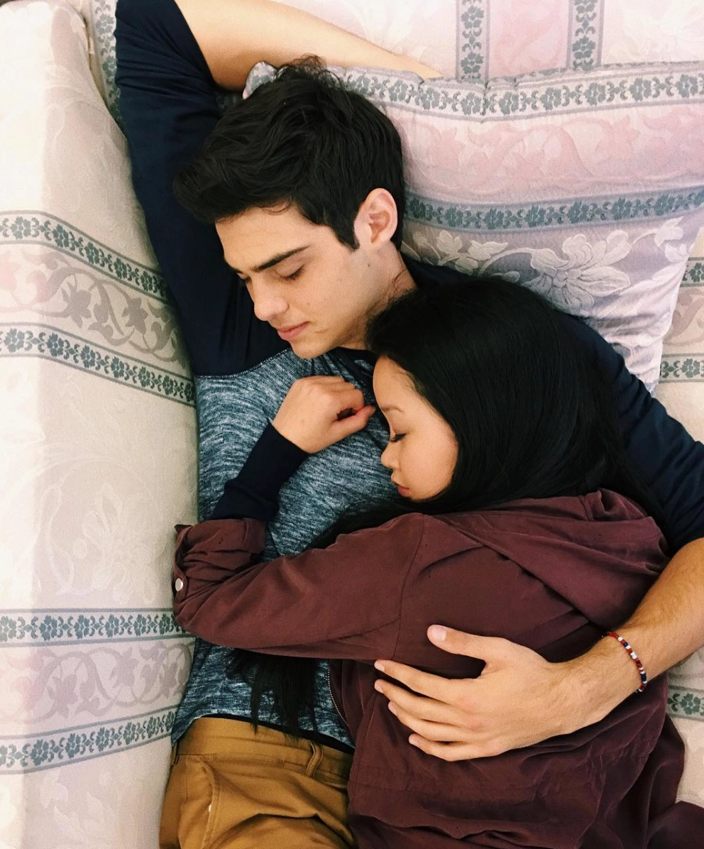 noah centineo as peter kavinsky, and lana condor as lara jean song covey in to all the boys series cuddling on bed