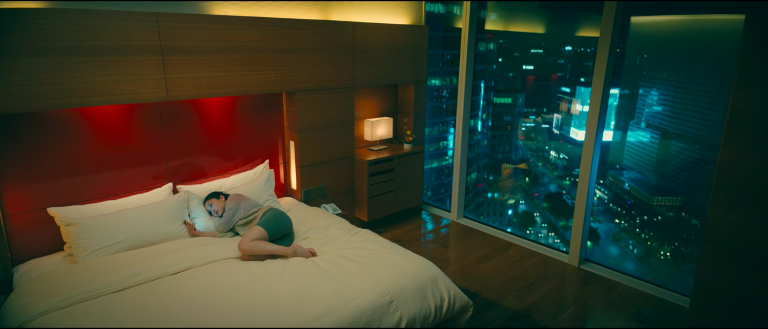 to all the boys: always and forever lara jean laying in bed with samsung station COEX in the background (view outside window at night))