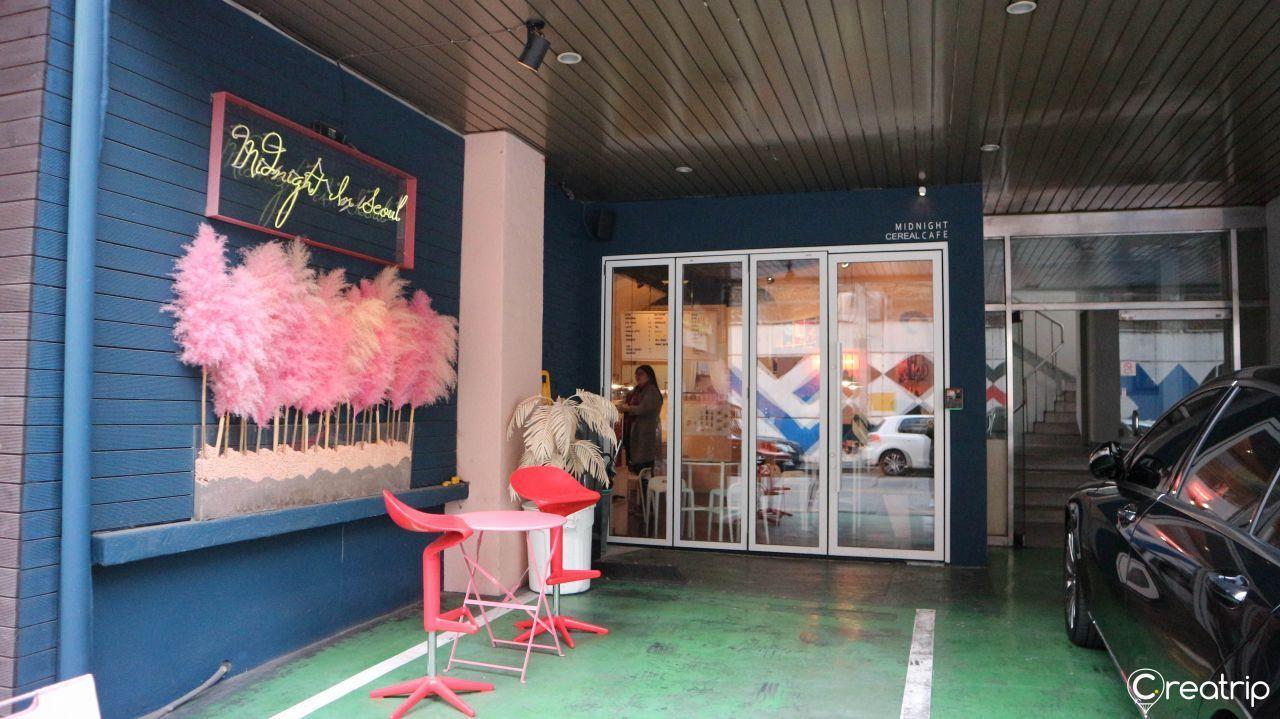 Entrance of Midnight in Seoul, featuring pink decor that adds to its charming atmosphere and attracts many visitors.
