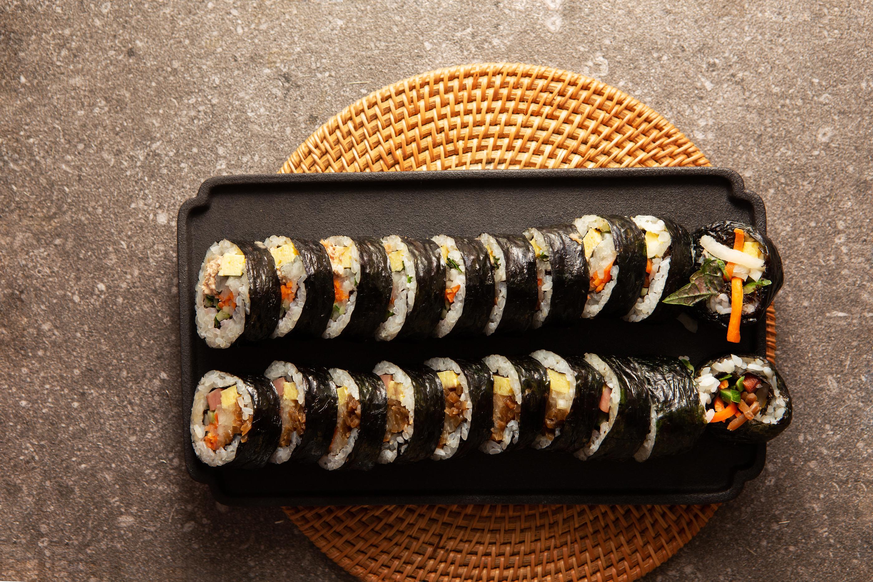 two sliced rolls of korean dish gimbap on plate