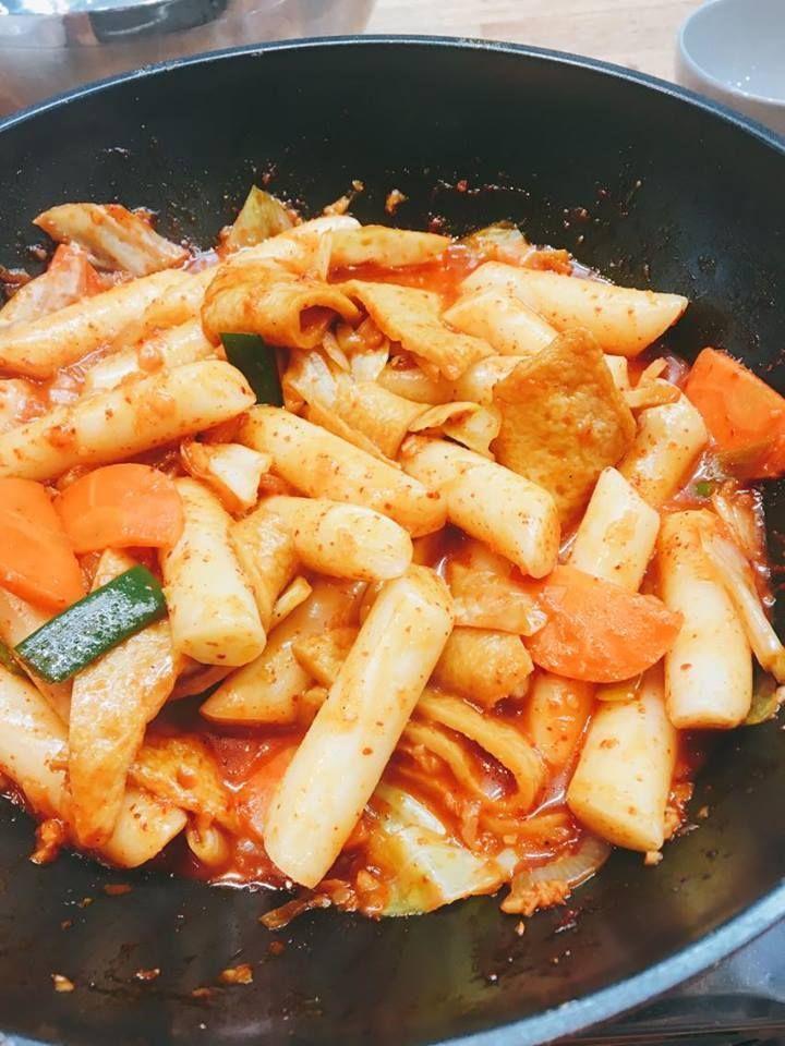 Close-up of spicy stir-fried rice cakes, known as tteokbokki, cooked in a pan.