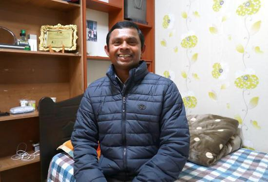 在庭院或屋內坐著身穿膨脹外套的人，背景是整潔的家庭環境。