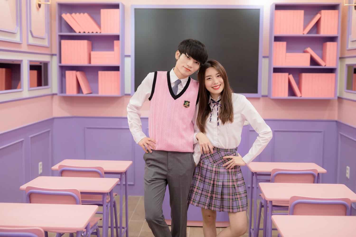 A group of people wearing fancy Ewha school uniforms and tartan dress shirts smiling and having fun at a social event in Korea.