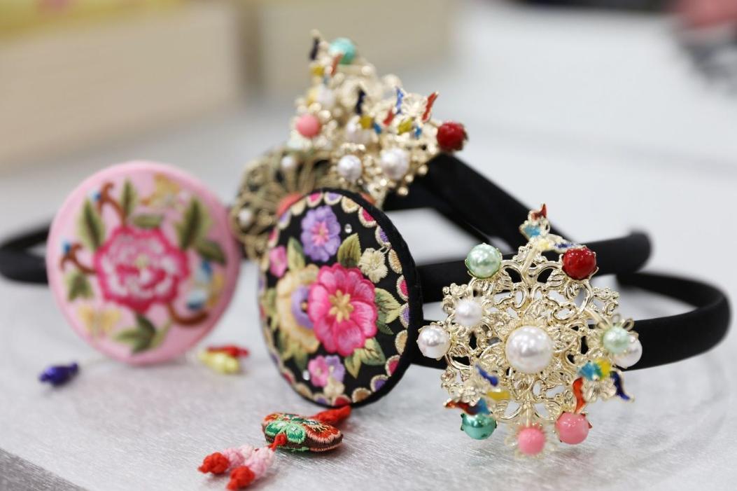 traditional hanbok dress accessories with handmade magenta body jewelry and natural hair ornament at Hanbok rental shop around Gyeongbokgung palace.