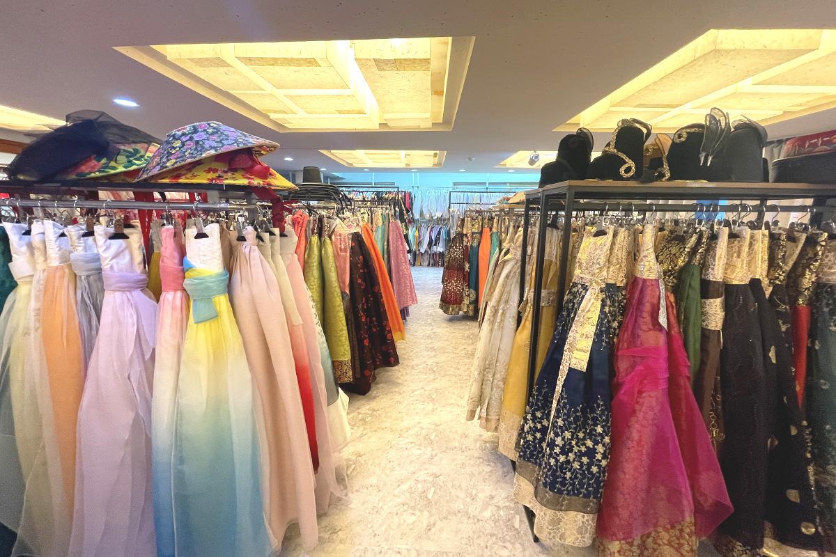 Hanbok rental shop around Gyeongbokgung, Seoul featuring trendy outerwear and textiles on clothes hangers.