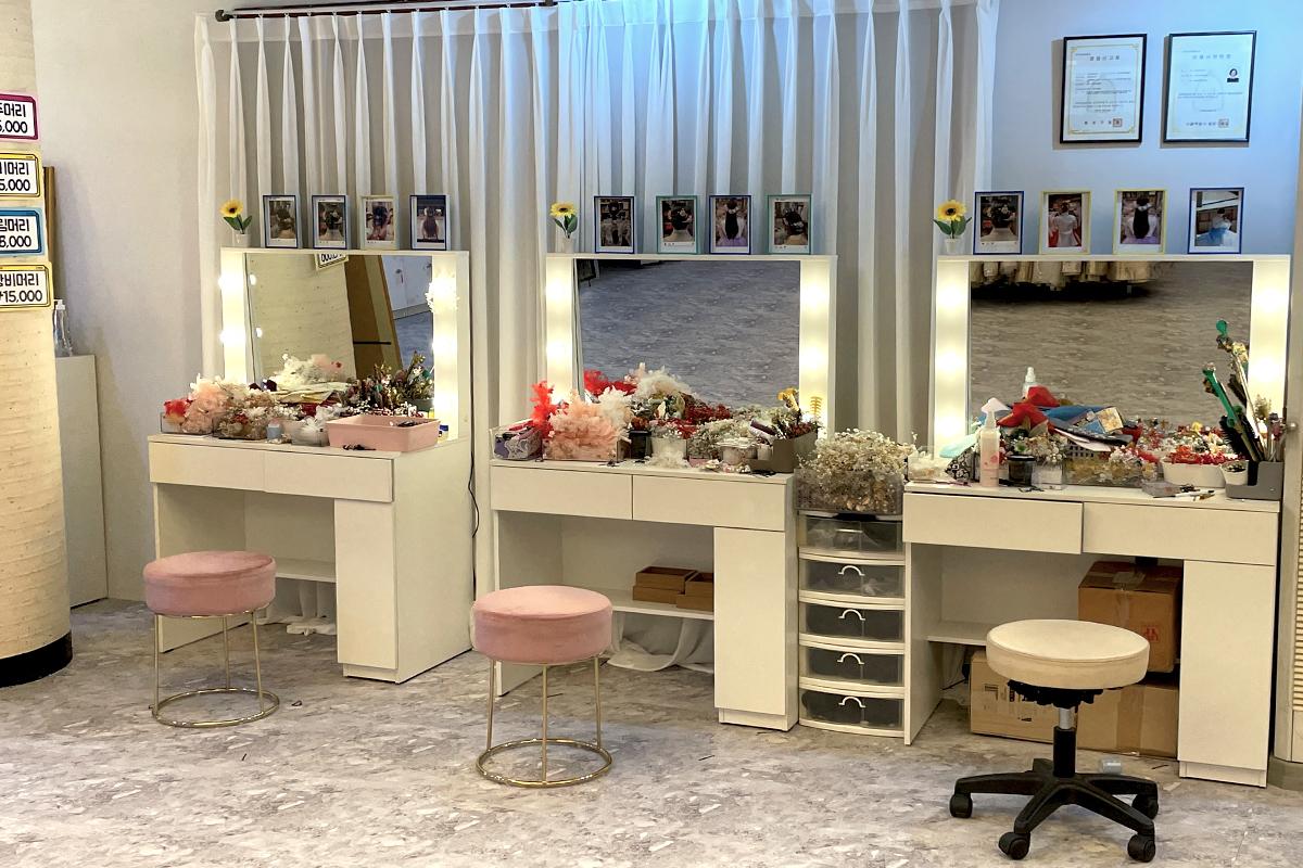 Interior design of a hanbok rental shop in Gyeongbokgung, Korea featuring furniture, house plants, shelving, and decor.