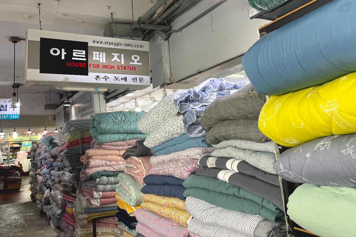 retail market selling textiles, plastic, and gas in 광장시장 88호 아르페지오, Korea.