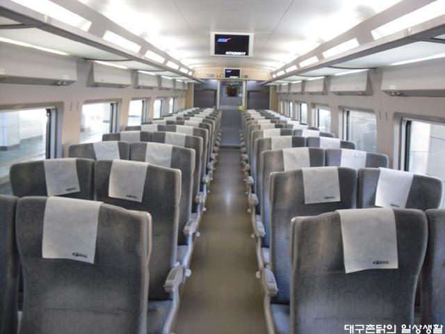 Interior of KTX passenger train with aisle and seating in Korea