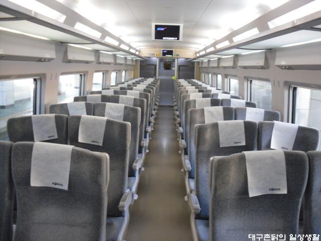 Interior of KTX passenger train with aisle and seating in Korea