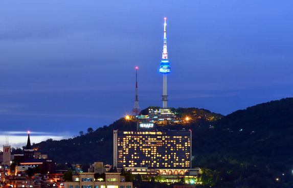 View of N Seoul Tower and city skyline from observation deck of NamSan Tower.