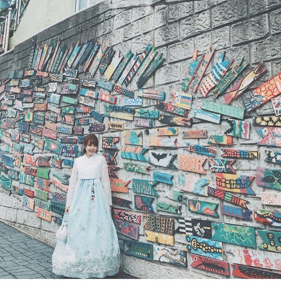 Colorful mural and graffiti on a 한복잇집 storefront in Seoul, featuring traditional Korean patterns and modern urban designs.