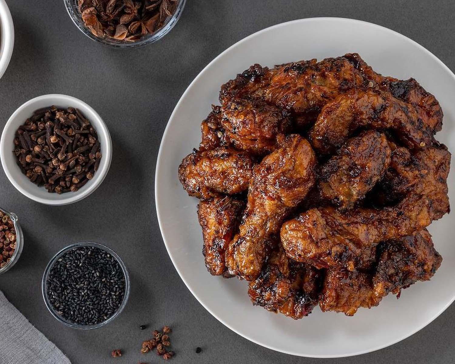 Delivery of 교촌치킨 with ingredients and tableware on a dining table for a delicious deep-fried dish.