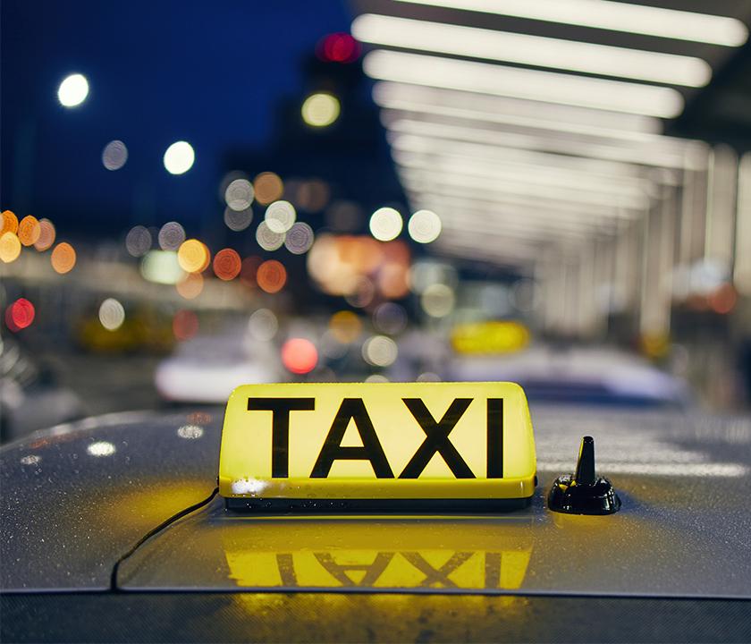 Taxi sign at Incheon Airport with automotive lighting and hood on a Seoul road.