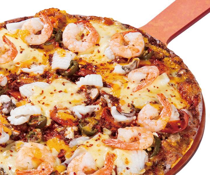 Delicious pizza and Karahi stew served on tableware, showcasing the best of Korean cuisine with fresh ingredients and meat.