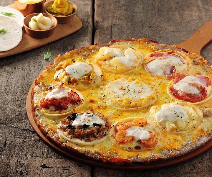 Delicious pizza on a plate with ingredients and tableware, from Korean pizza delivery service.