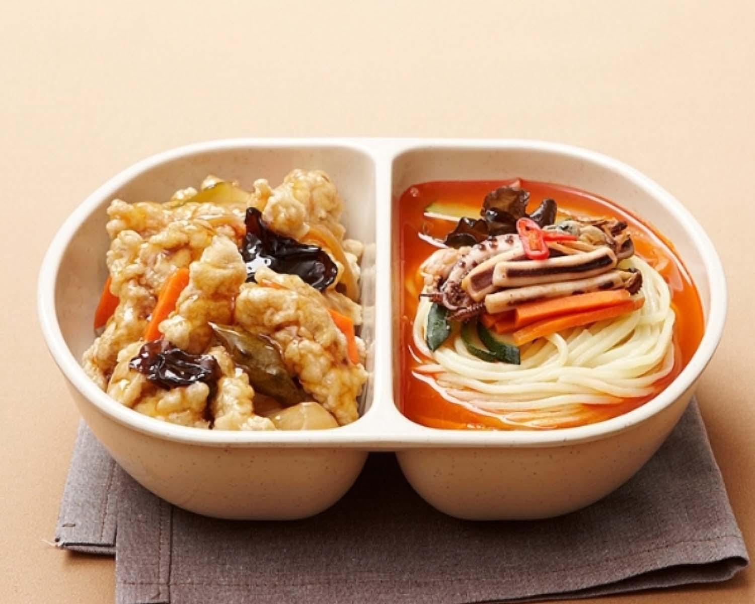A delicious Chinese food delivery with Tangsuyuk and Jjambbong set, served with tableware and ingredients.