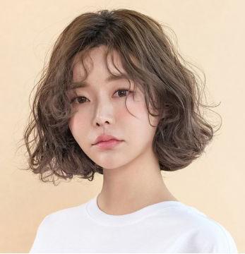 Model with styled hair showcasing facial features, including forehead, nose, cheeks, lips, chin, eyebrows, eyes, eyelashes, and jaw, at Juno Hair Salon in Centum City Station, Busan.