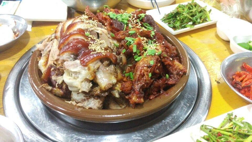 Delicious Korean cuisine - Plate of crispy fried pork belly and boiled pork with various vegetables and tableware. Perfect for delivery or dining