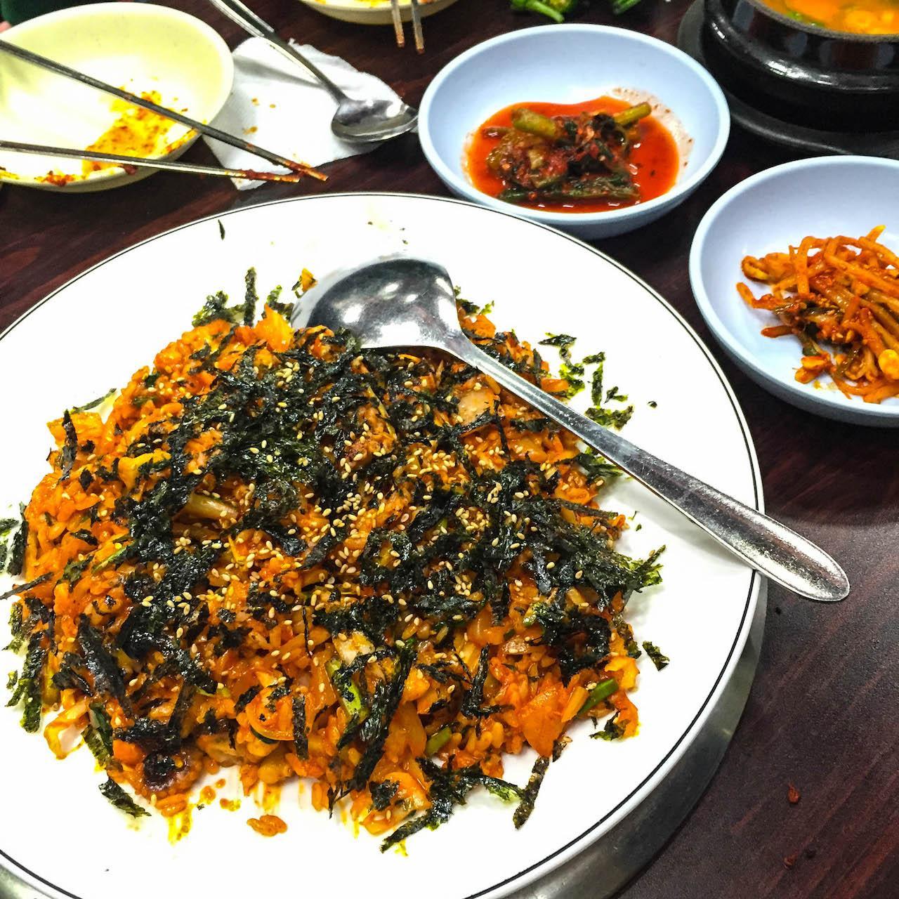 dish of grilled spicy squid and bulgogi served with various ingredients and tableware, perfect for Korean cuisine lovers.