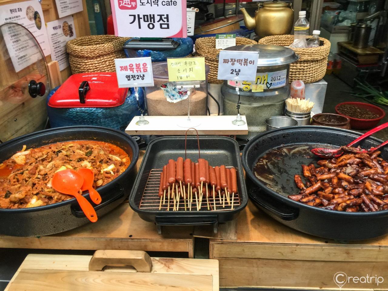 Colorful ingredients and kitchen appliances at the bustling Tongin Market in Korea, perfect for cooking up delicious Korean cuisine.