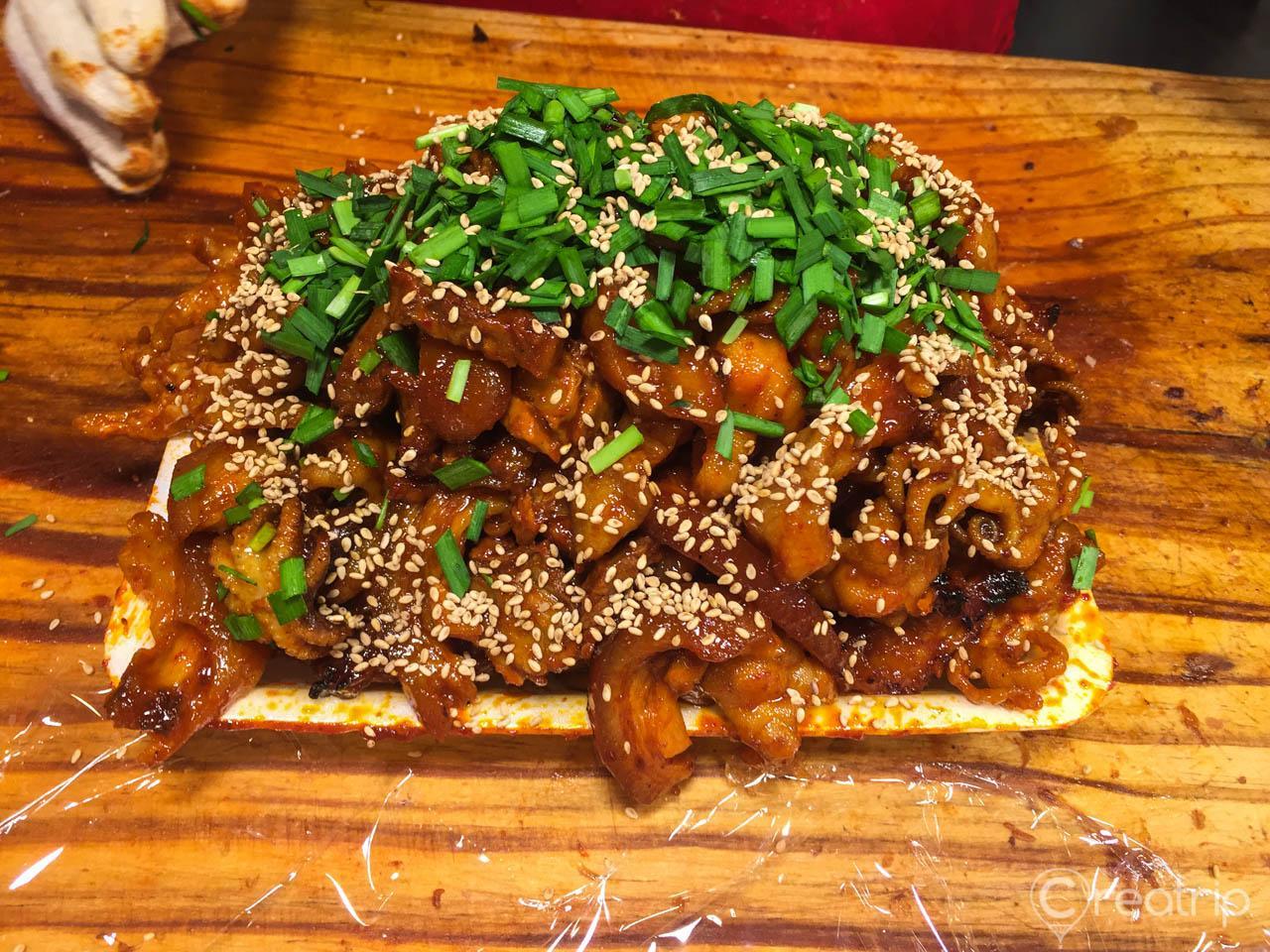 Spicy jokbal (pigs' feet) with sesame mixture, served on tableware at Changsin-dong's main branch.