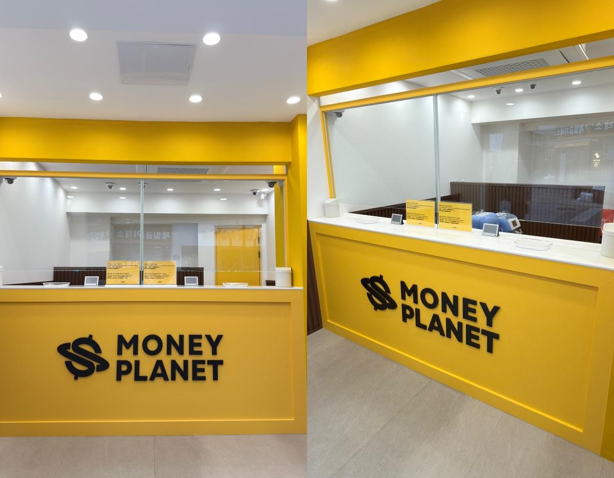 Bright yellow MONEY PLANET currency exchange counter with glass service windows and signage in a Gwangbok-ro shopping area location
