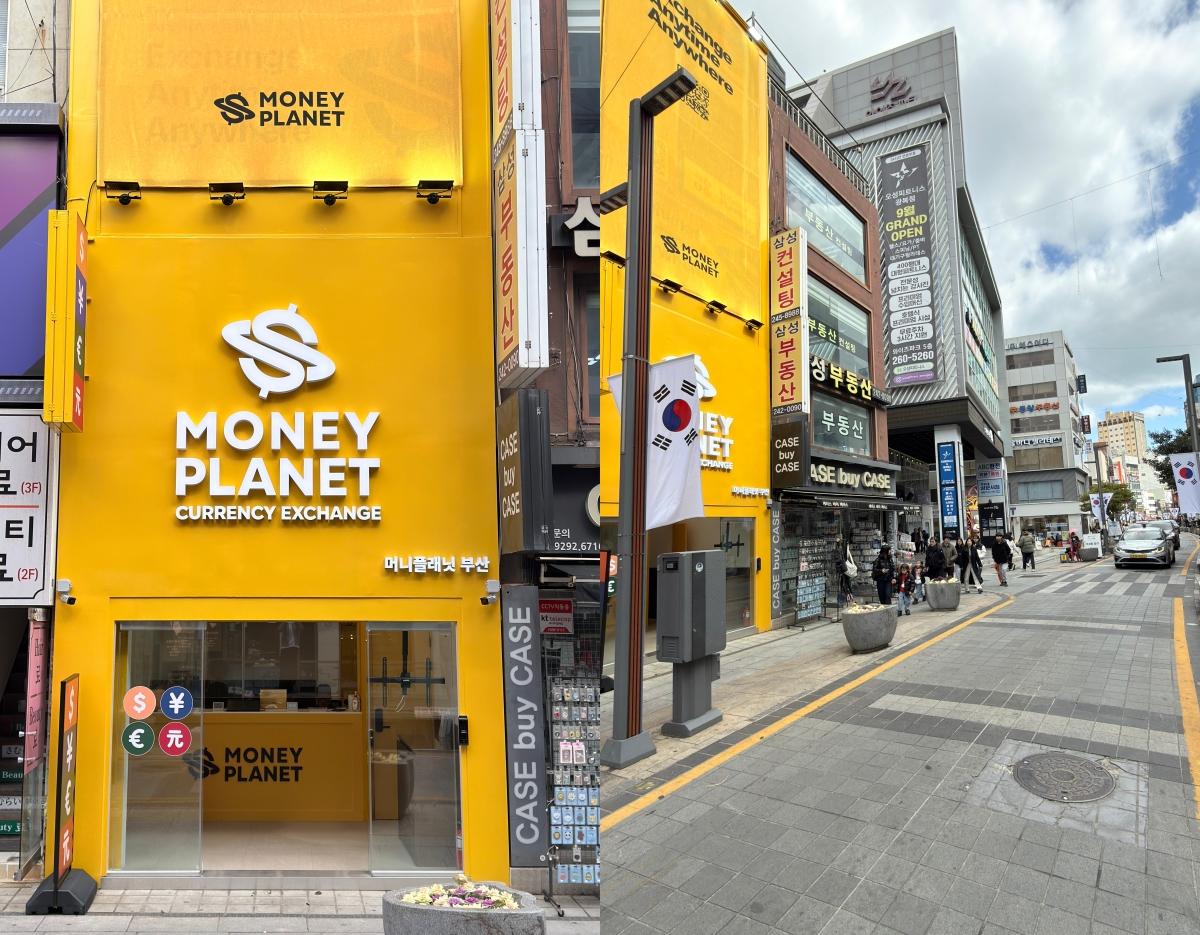 Bright yellow Money Planet currency exchange storefront on a busy Gwangbok-ro shopping street, South Korean flag hanging outside