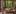 traditional wooden hanok tea room with low latticed tables, straw floor cushions, and large windows overlooking green garden