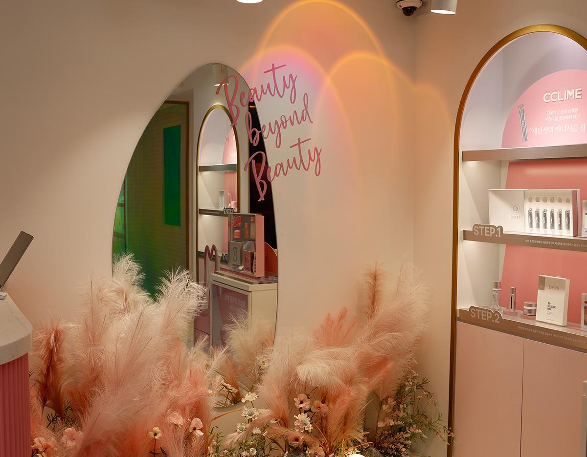 Seongsu CCLIME interior with arched mirror reading "Beauty beyond Beauty," pink pampas grass and skincare display shelves labeled STEP.