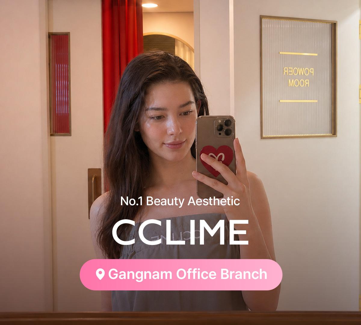therapist's hands massaging a client's oiled jawline and neck over a gray towel at a beauty esthetic clinic