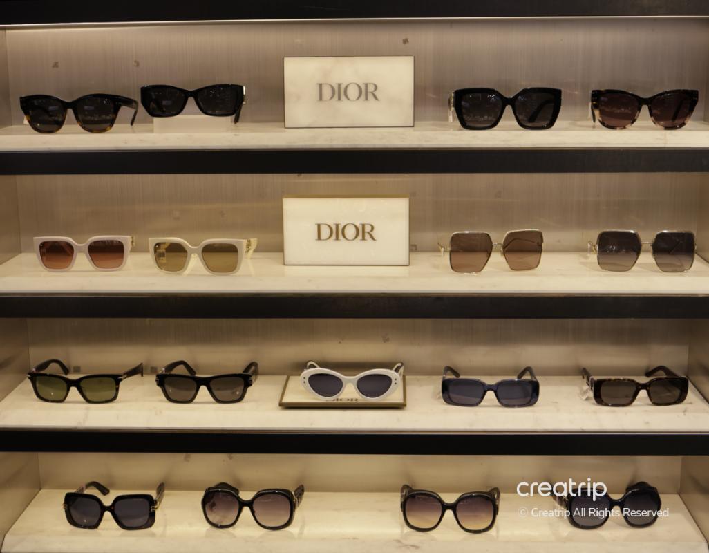 Display shelves filled with assorted Dior sunglasses in various shapes and colors at 룩옵티컬 강남역점.