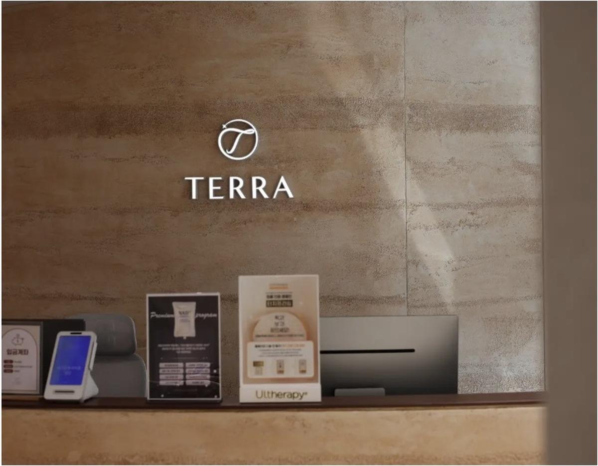 Terra clinic illuminated TERRA logo above the reception desk