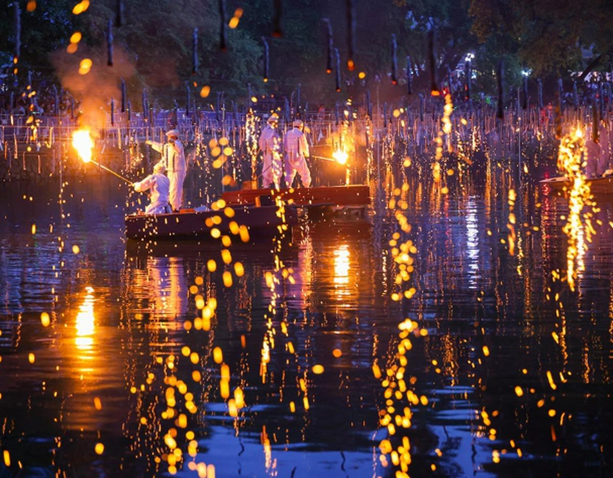 Haman Nakhwa Nori Festival fire sparks falling over the pond at night