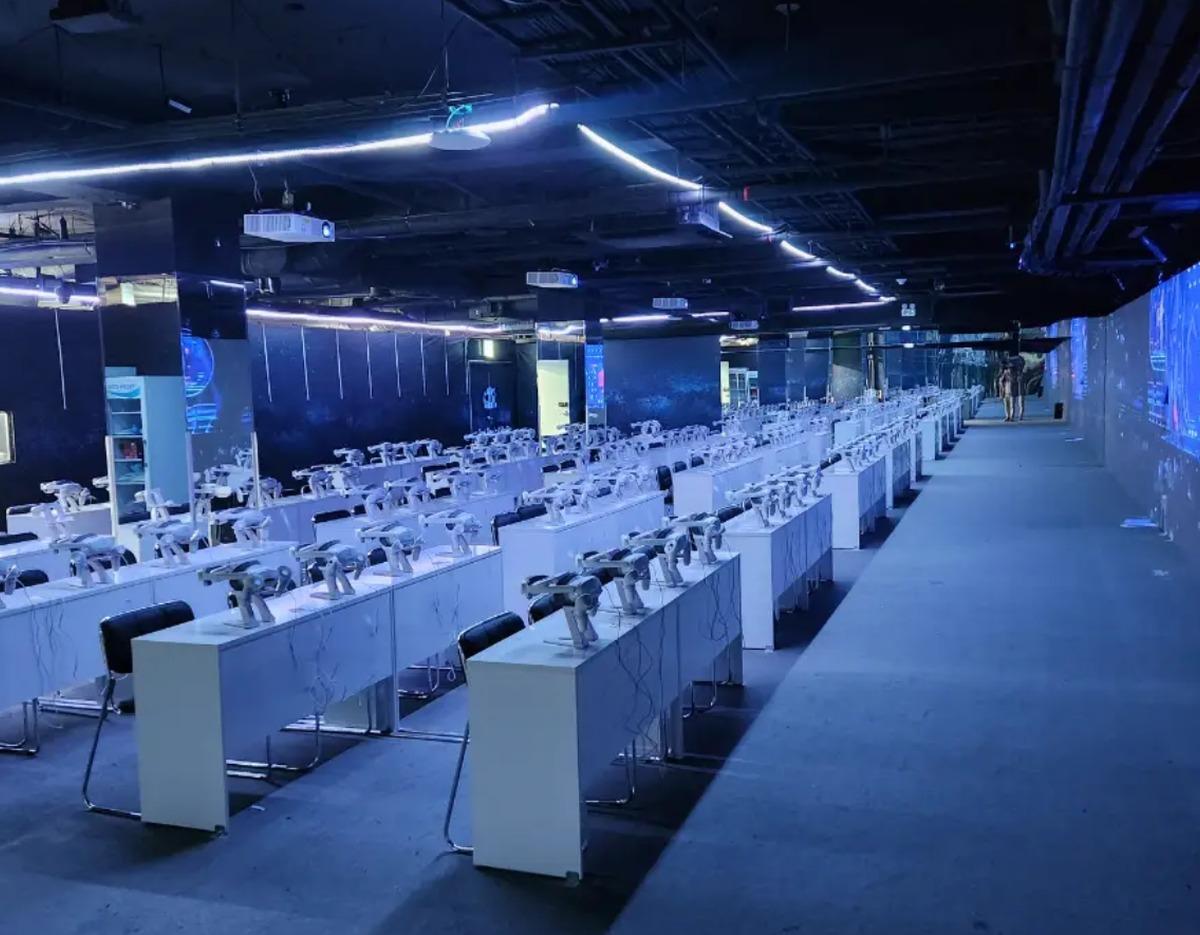 K-Culture VR Tower VR theater rows of white desks each with 4K VR headsets and chairs under blue LED ambient lighting