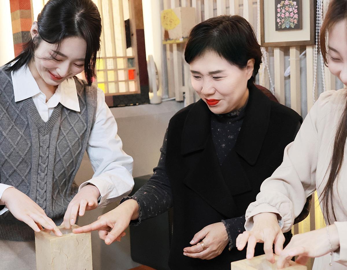 跟著名匠指导制作韩纸工艺的样子