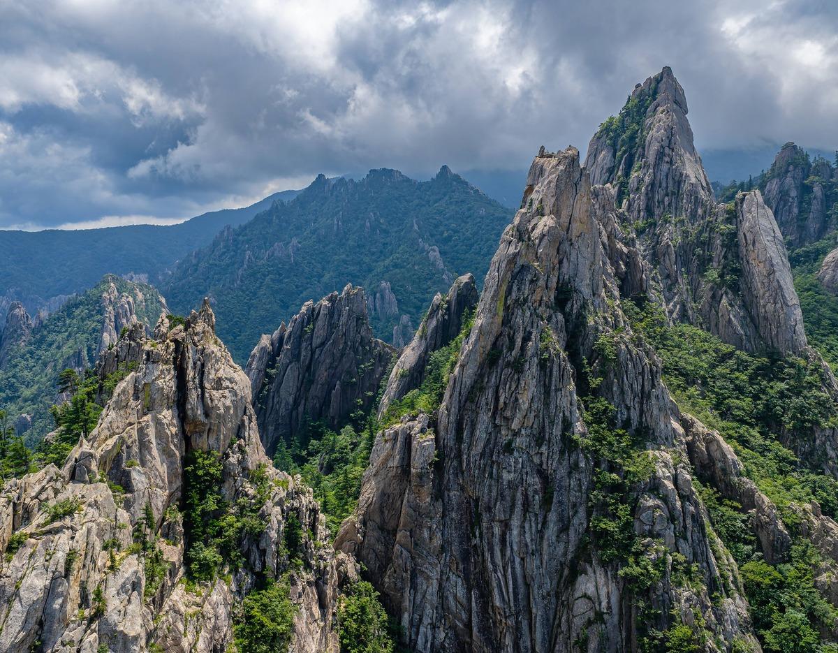 Seoraksan rugged granite spires and forested ridges under dramatic clouds, view highlighting Ulsanbawi rock formation