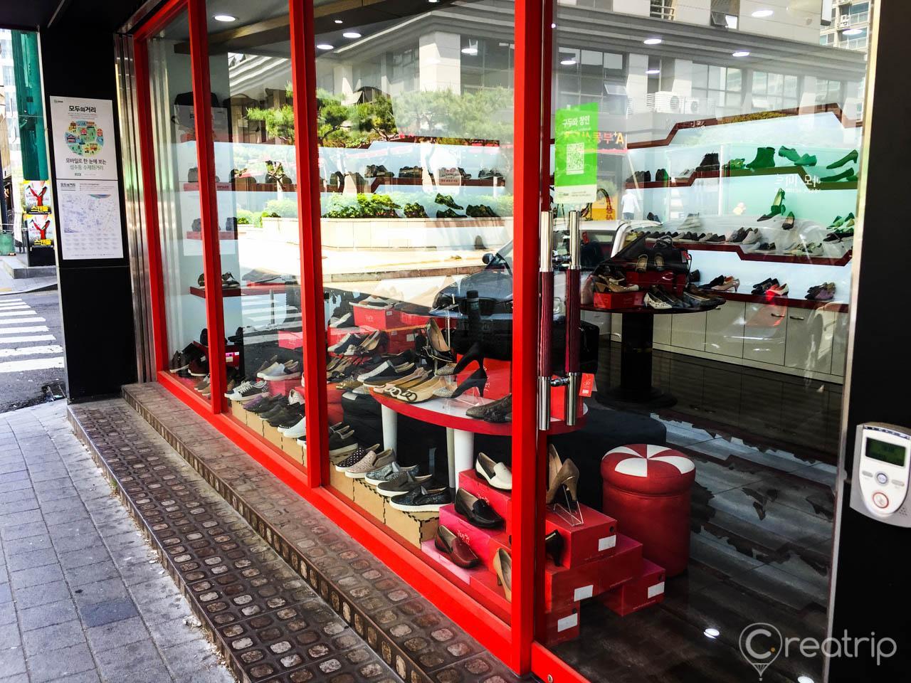 View of the automotive-themed street in Seoul's trendy Seongsu-dong neighborhood featuring a variety of buildings and tire store.