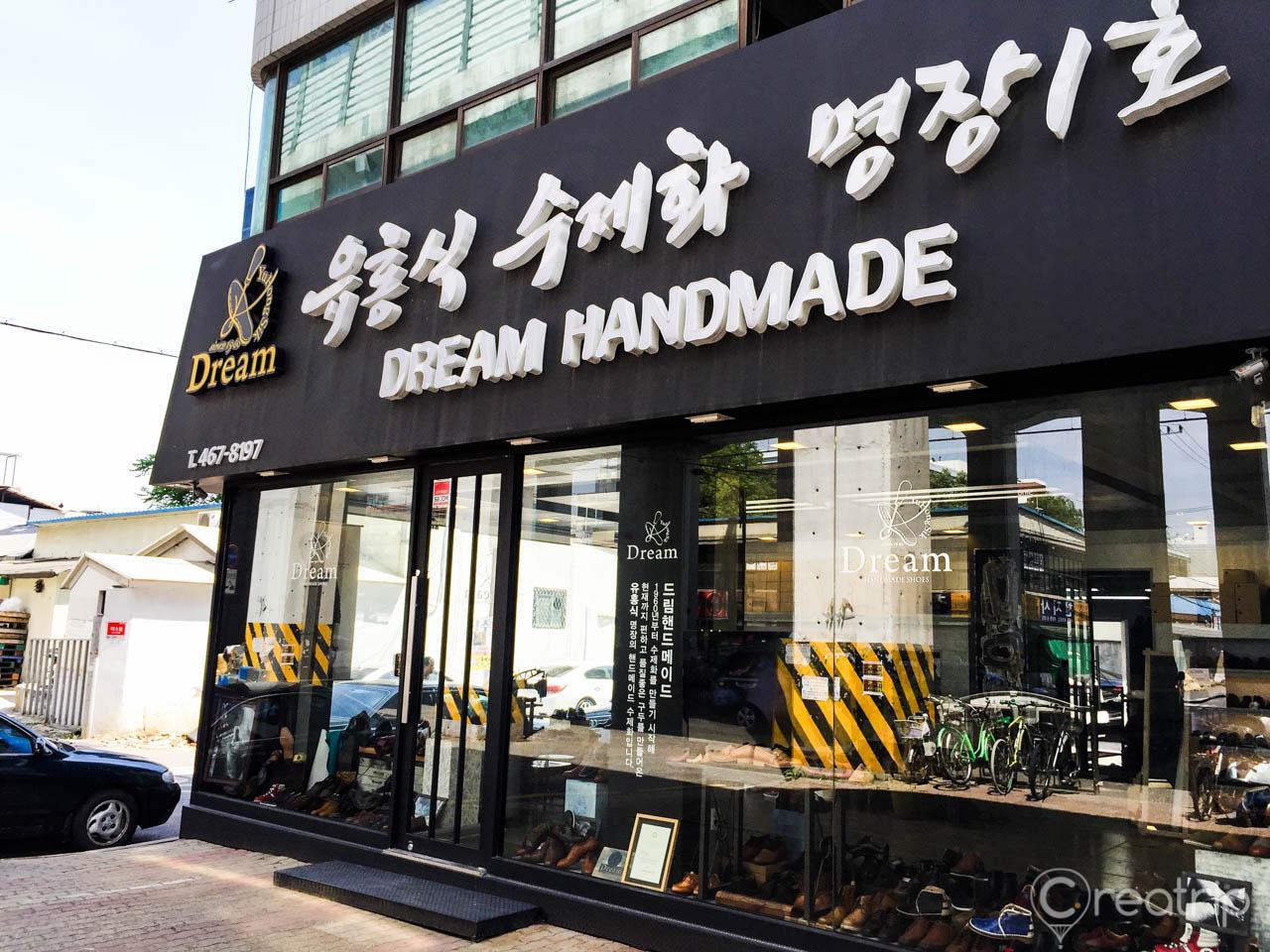 Retail building facade in Seoul's trendy Seongsu-dong showcasing handmade shoes in a tire and wheel display.