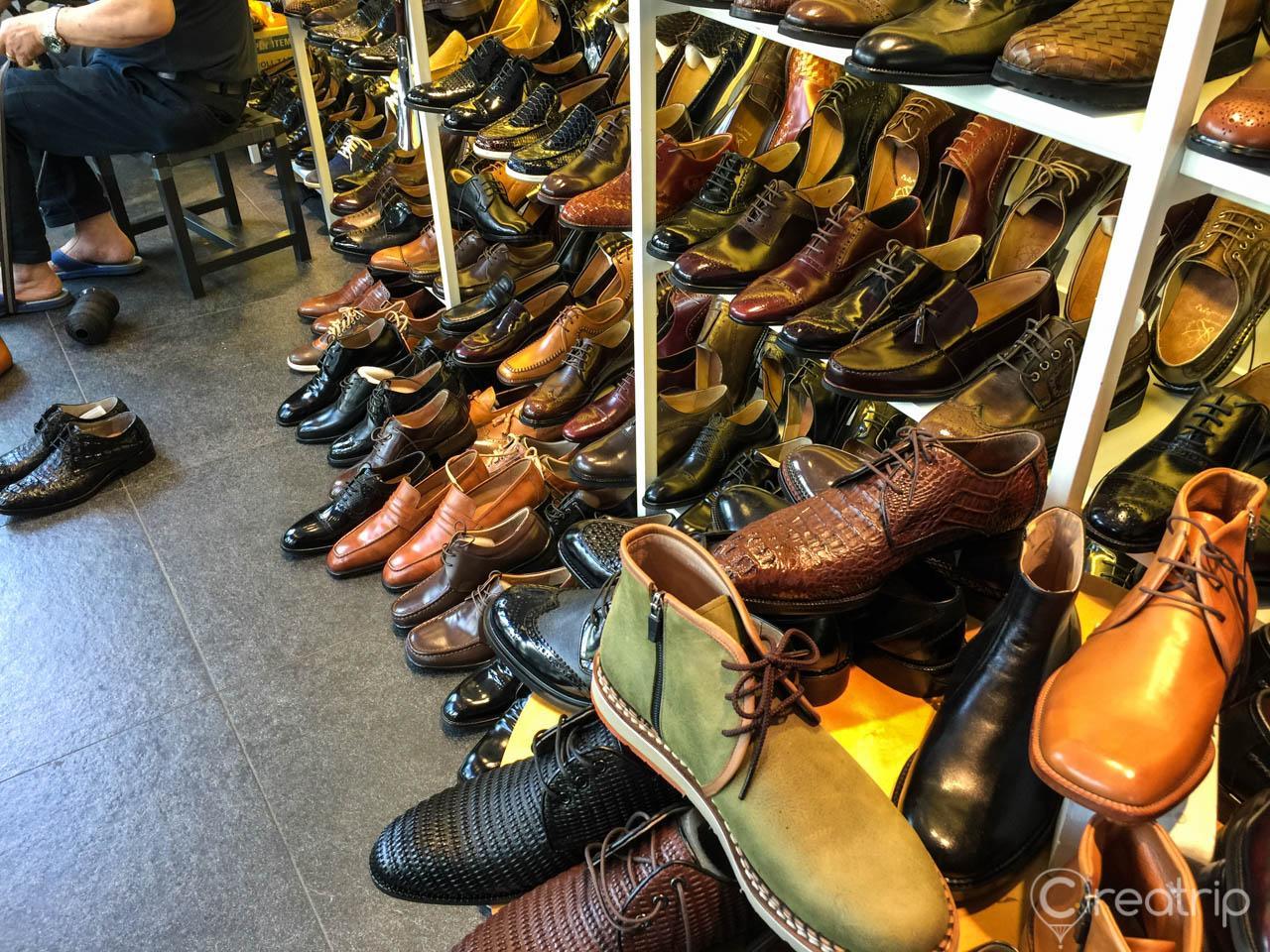 Colorful handmade footwear and accessories on display at a bustling street of 성수동 neighborhood in Seoul, Korea.