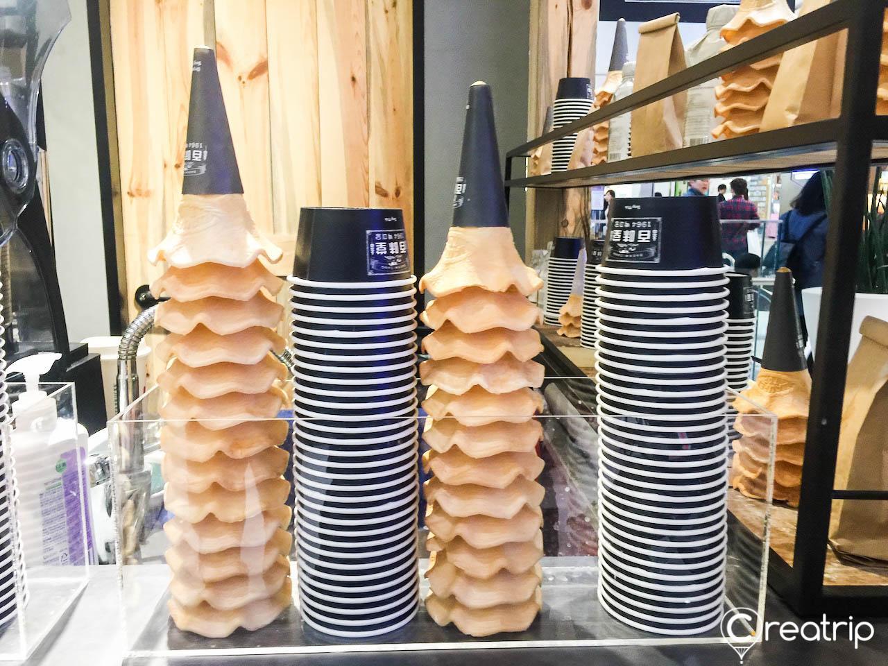 Display of automotive-inspired eyewear, gas-inspired barware, and delicacies at Bacchus Lounge in Seoul's Times Square.