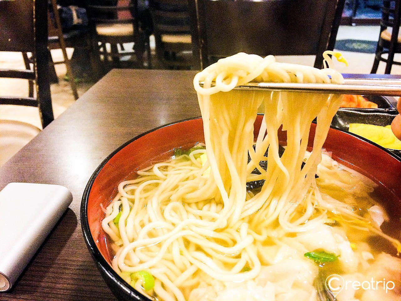 noodles on tableware at 18번완당집, a popular Busan 우동맛집 in Seoul, South Korea.
