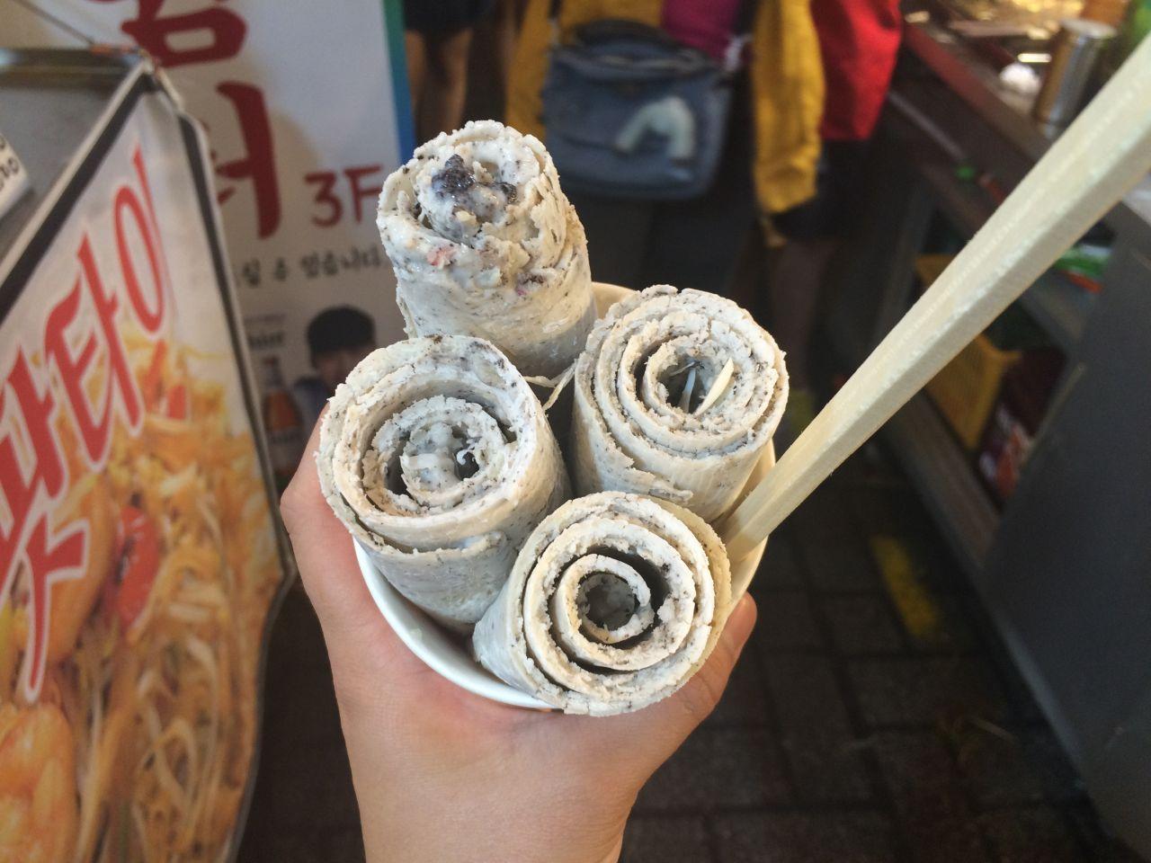 Bupyeong Gangtong Market - a selection of Korean comfort food including ice cream, served on paper plate.