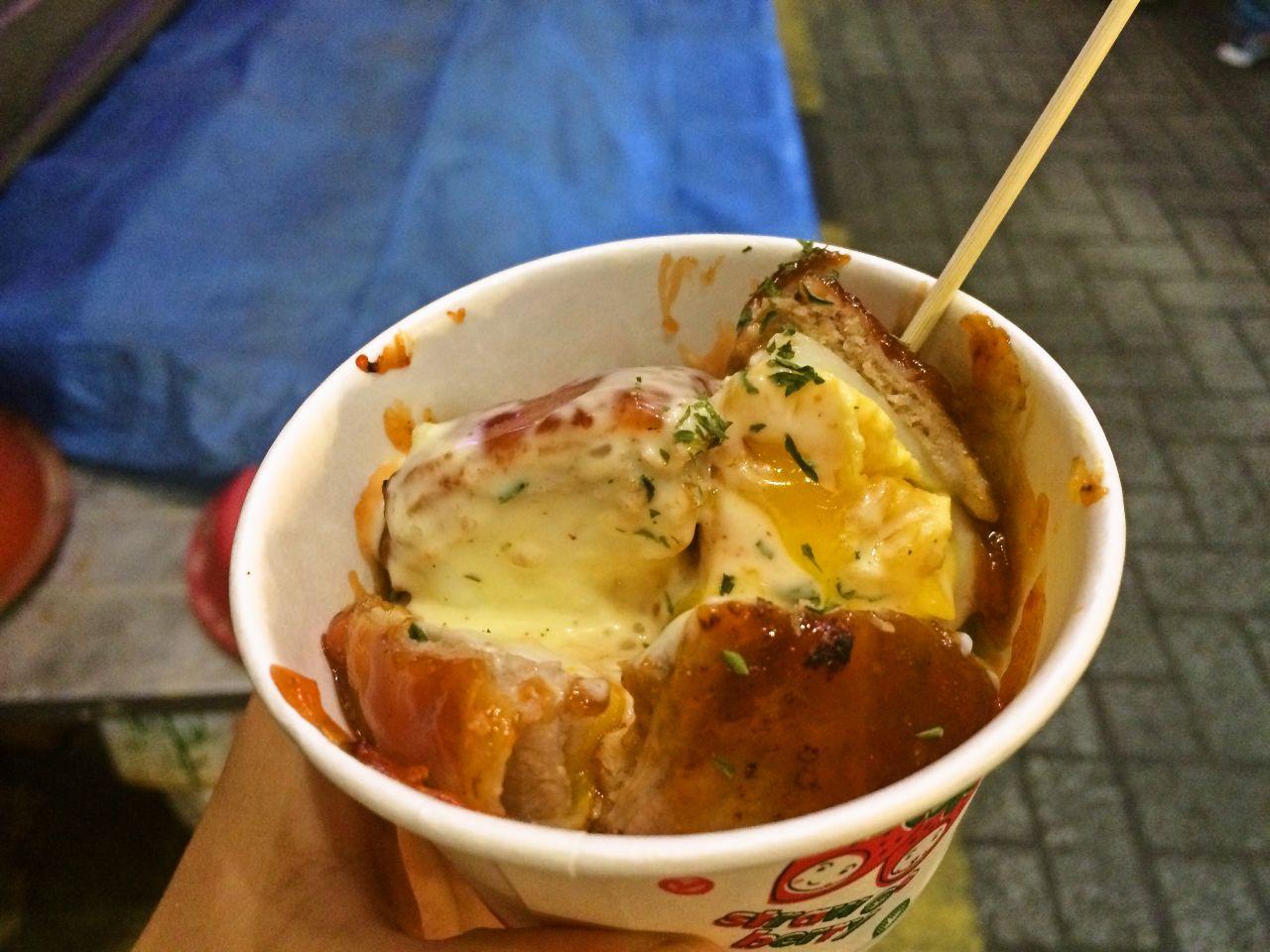 Various street foods displayed at the bustling 부평깡통시장 (Bupyeong Kkangtong Market) in Korea.