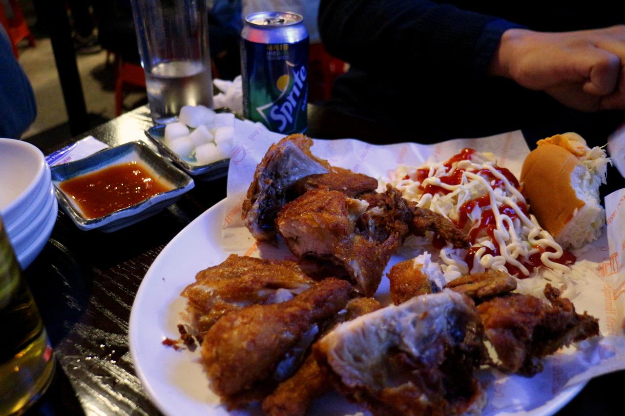 grilled hotdog with toppings on a plate, perfect for a tasty meal or snack.