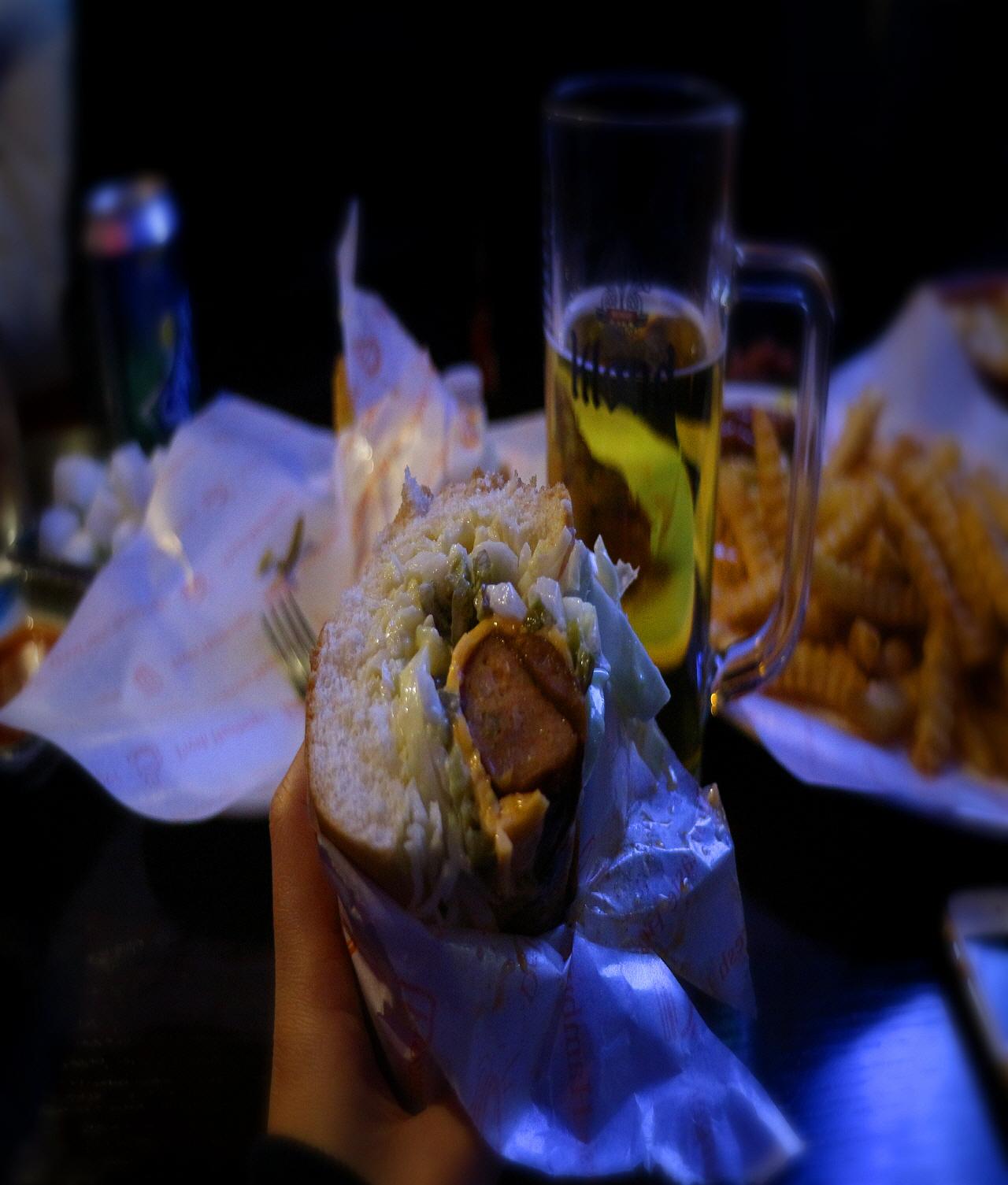 delicious hot dogs with various toppings and crispy golden fries on a table.
