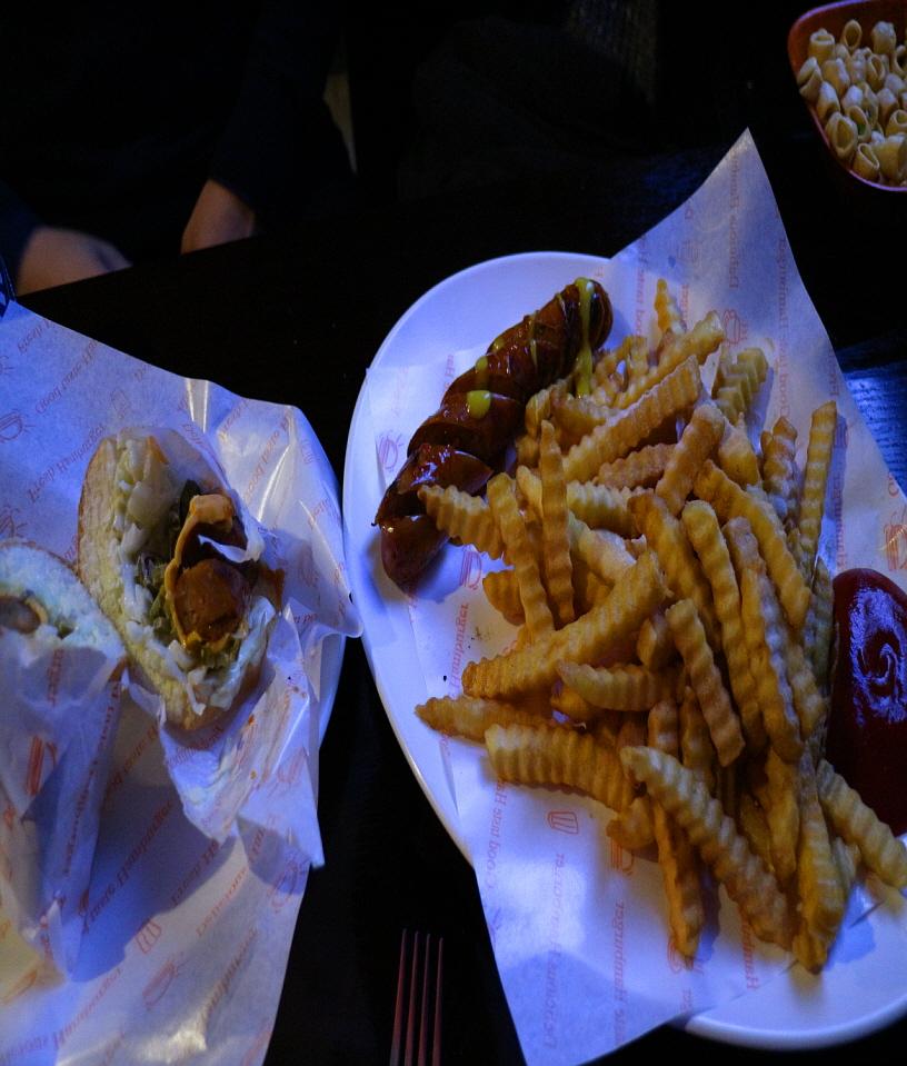 delicious MiSo Hot Dog dish served on a plate with tableware and ingredients. A staple fast food recipe in Seoul, Korea. Deep fried for a crispy texture.
